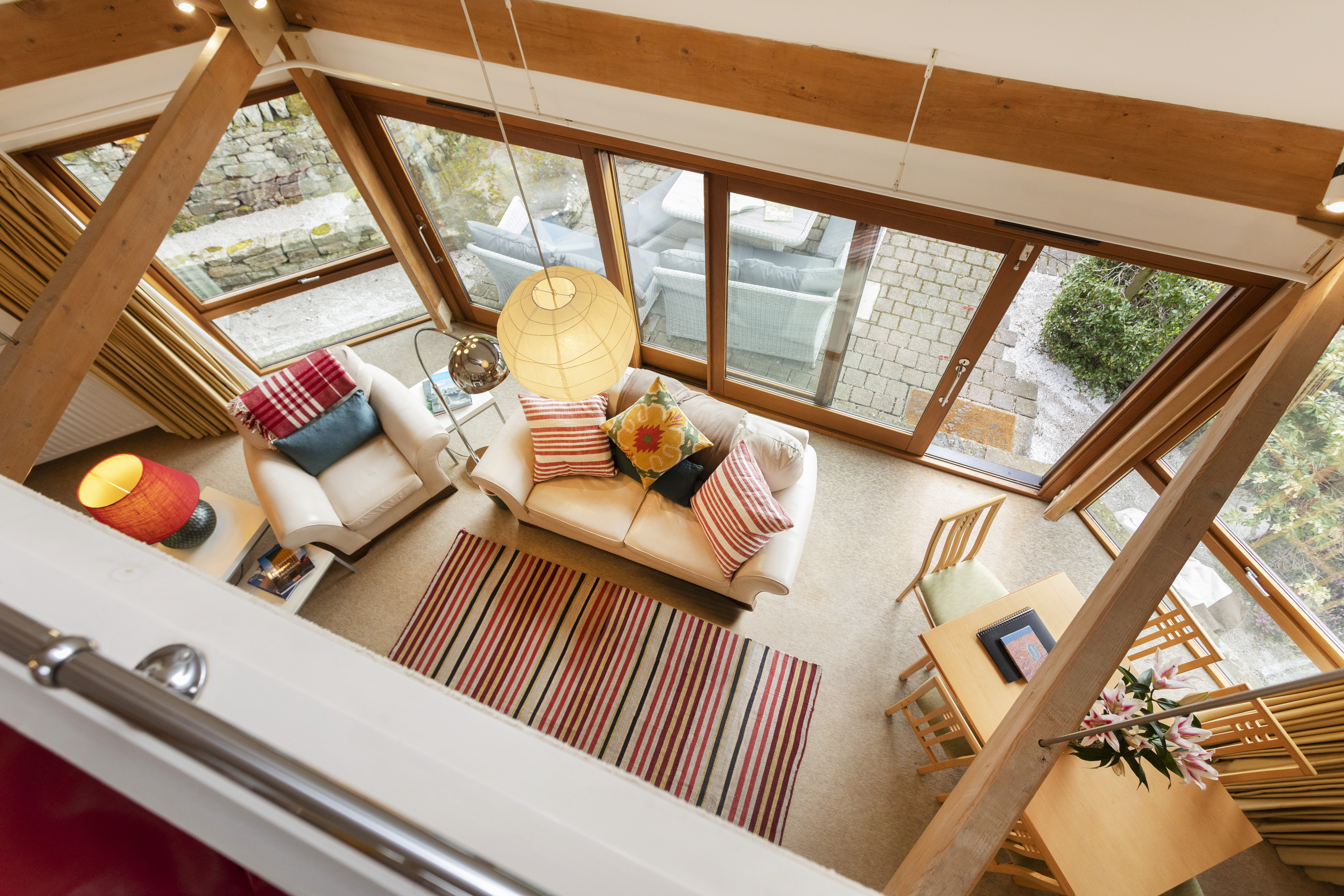 The light-filled, architect-designed living space at The Round House, seen from the mezzanine