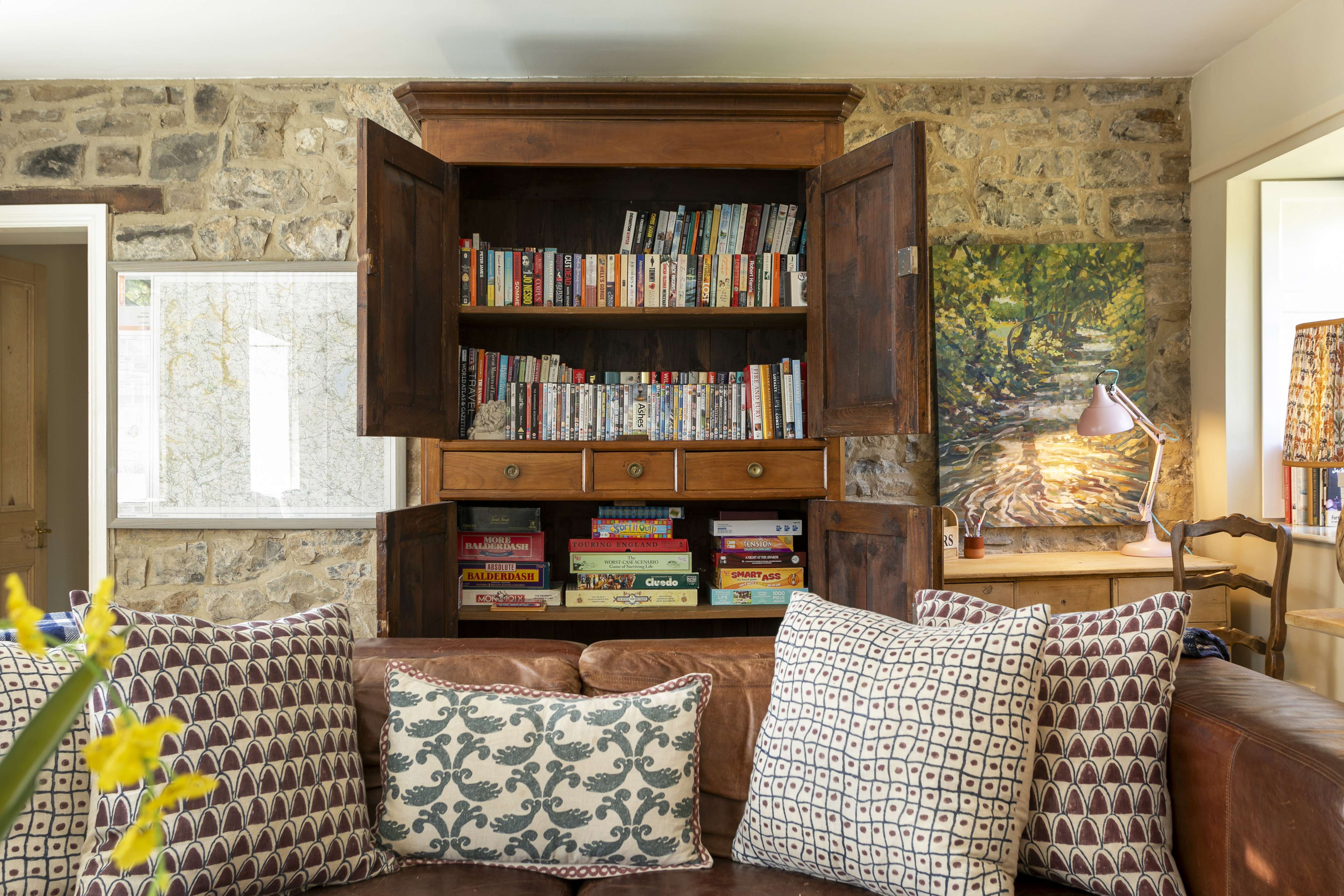 Bookshelves and games at Swallow's Cottage